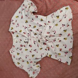 A cream top with flowers